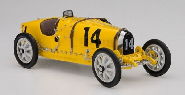 Yellow vintage race car diecast model with number 14, 1:18 scale, detailed wheels and cockpit