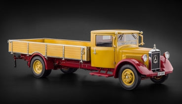 Yellow and red diecast vintage Mercedes truck model on black background, 1:18 scale collectible