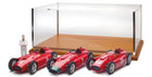 Three 1:18 scale red vintage model race cars with display case and driver figure