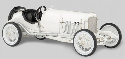 White vintage diecast model race car with black seats, detailed engine, and spoked wheels