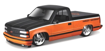 Diecast model pickup truck in black and orange with custom wheels and Harley-Davidson graphics