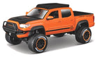 Orange diecast Toyota pickup truck model with Harley-Davidson graphics and off-road tires