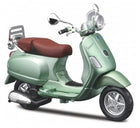 Green diecast model Vespa scooter with brown seat, detailed mirrors and wheels