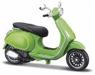 Green diecast model scooter with black seat and chrome accents on white background