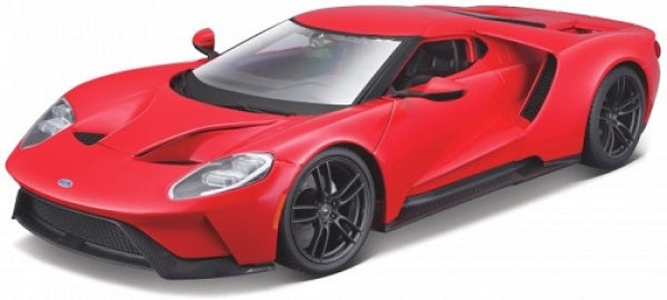 Red diecast model sports car with black wheels, detailed headlights, and aerodynamic design