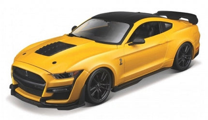 Yellow diecast model sports car with black roof and hood vents, 1:18 scale collectible