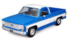 Blue and white diecast model pickup truck 1:18 scale, detailed vintage design