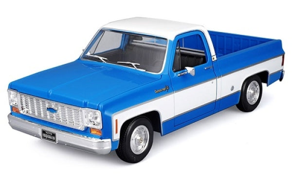 Blue and white diecast model pickup truck 1:18 scale, detailed vintage design