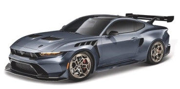 Diecast model sports car in metallic gray with wide body kit, racing spoiler, and detailed rims.