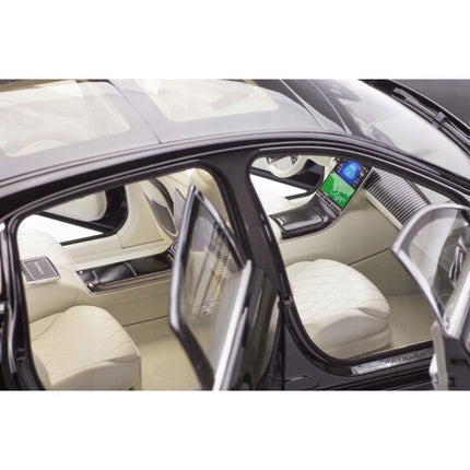 Close-up interior view of the 1:18 scale Mercedes-Maybach S 680 4Matic (X223) diecast model, focusing on the luxurious beige quilted leather seats, wood-trimmed dashboard with digital display, and panoramic glass roof. The open door frames the plush cabin, highlighting the detailed steering wheel and centre console.