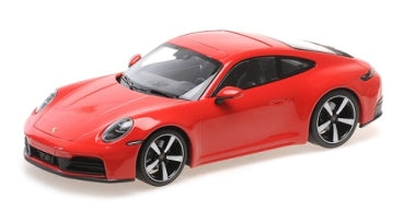 Red 1:18 scale diecast model Porsche sports car with black wheels on white background