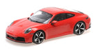 Red Porsche 911 diecast model car 1:18 scale with black and silver wheels on white background