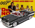 Diecast 1:24 scale black convertible model car with red interior in front of vintage James Bond Dr. No movie poster.