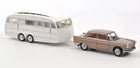 1:18 scale diecast model brown classic car towing white vintage caravan, on white background