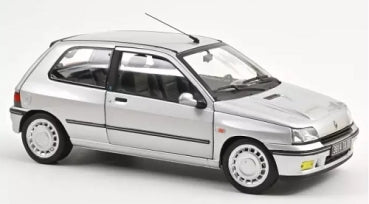 1:18 scale silver diecast model car, compact hatchback, detailed exterior, displayed on white