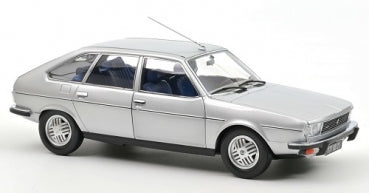 Silver diecast model car, 1:18 scale, four-door sedan with detailed wheels and blue interior.