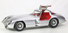 Silver diecast model car with gullwing doors and red interior, 1:18 scale collectible