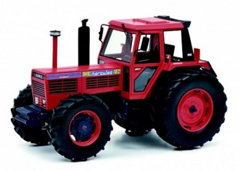 Red diecast model tractor with detailed cab and large black tires, displayed on white background.