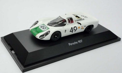 White Porsche 907 diecast model car with race number 49 on display base