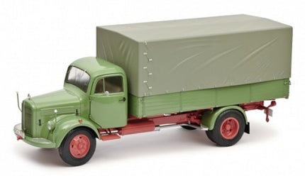 Green vintage diecast model truck with covered cargo bed, 1:18 scale collectible vehicle