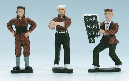 Three painted diecast figurines in vintage racing attire, one holding a pit board sign