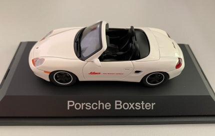 White Porsche Boxster 1:43 diecast model car with black interior on display base