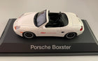 White Porsche Boxster 1:43 diecast model car with black interior on display base