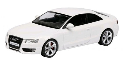 White diecast model car Audi coupe in 1:43 scale, detailed exterior, collectible toy.