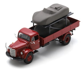 Red vintage diecast truck carrying covered car model, 1:18 scale collectible