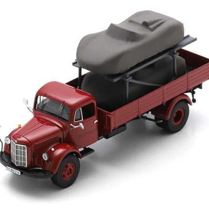 Red diecast model vintage transport truck with covered race car, 1:18 scale replica.