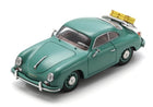 Green diecast model car with yellow luggage on rear rack, classic coupe design, 1:18 scale
