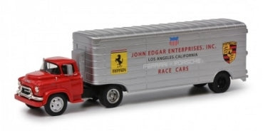 1:43 scale diecast model of red and silver vintage race car transporter truck with Ferrari and Porsche logos