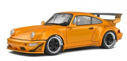 Orange diecast model car with wide body kit, black wheels, and large rear wing, 1:18 scale