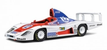 1:18 scale diecast model of a white, red, and blue vintage racing car with rear wing