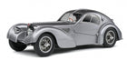 Silver classic diecast model car in 1:18 scale with curved fenders and vintage design