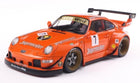 1:18 scale orange Porsche 911 diecast model race car with detailed decals and rear wing