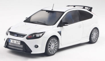White diecast model car in 1:18 scale, sporty hatchback with detailed rims and rear spoiler