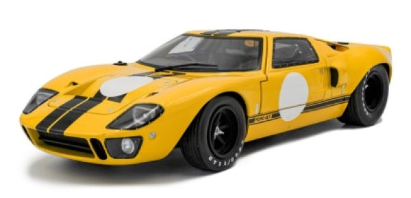Yellow 1:18 scale diecast model car with black racing stripes and vintage design
