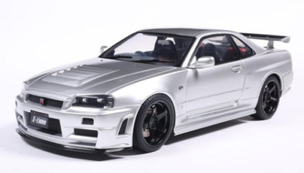 Silver diecast model car Nissan Skyline GT-R R34 in 1:18 scale with black wheels and rear spoiler