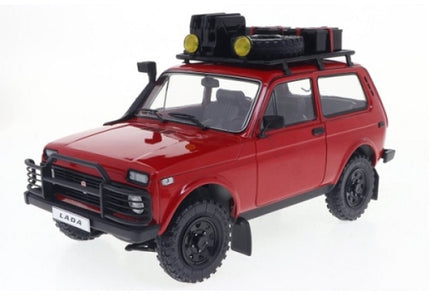 Red diecast Lada Niva 4x4 model car with roof rack, off-road tires, and accessory details