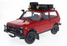 Red diecast Lada Niva 4x4 model car with roof rack, off-road tires, and accessory details