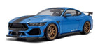 Blue 1:18 scale diecast Shelby model car with black racing stripes and gold wheels