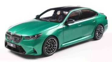 Green diecast model car sedan with black roof, detailed wheels, 1:18 scale collectible.