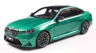 Green diecast BMW M sports sedan model car 1:18 scale with black roof and detailed wheels