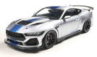1:18 scale diecast silver Shelby Mustang model car with blue racing stripes, detailed exterior