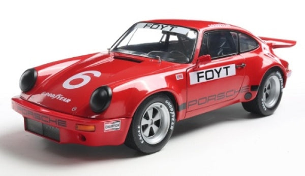 Red Porsche diecast model car with racing decals, number 6 and FOYT on side, 1:18 scale