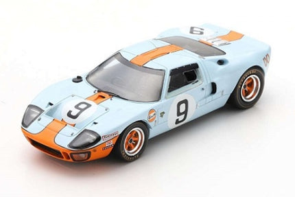 1:18 scale diecast model car, light blue with orange racing stripes and number 9 decals