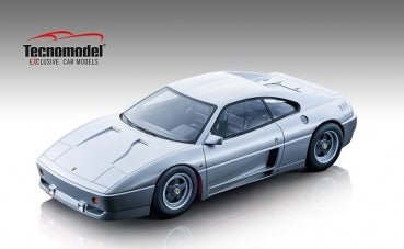 Silver diecast sports car model 1:18 scale with detailed exterior, displayed on a neutral background.