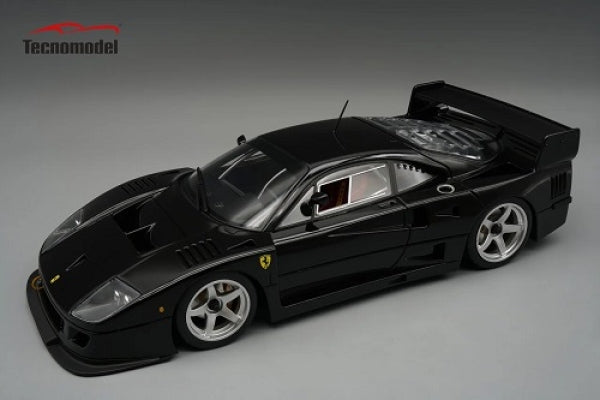 Black Ferrari F40 1:18 scale diecast model car by Tecnomodel, detailed with rear wing and silver wheels.