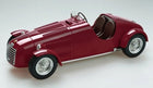 Red vintage diecast model car with wire wheels and brown seats, 1:18 scale collectible